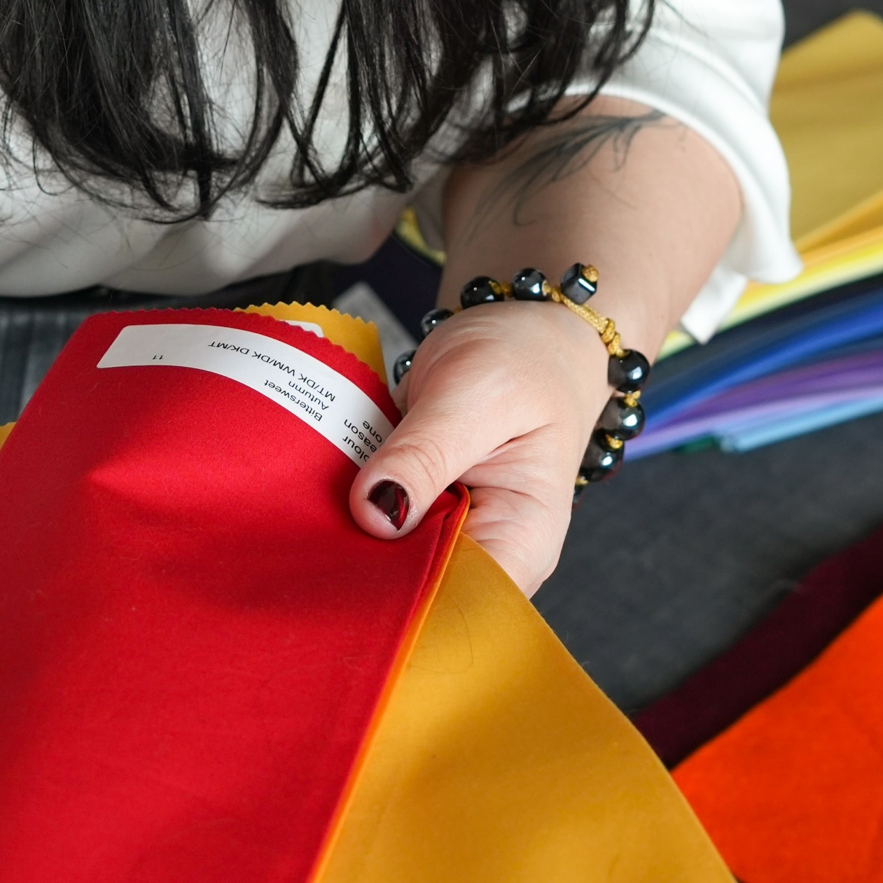 Francesca Moon holding drapes during a colour analysis coaching