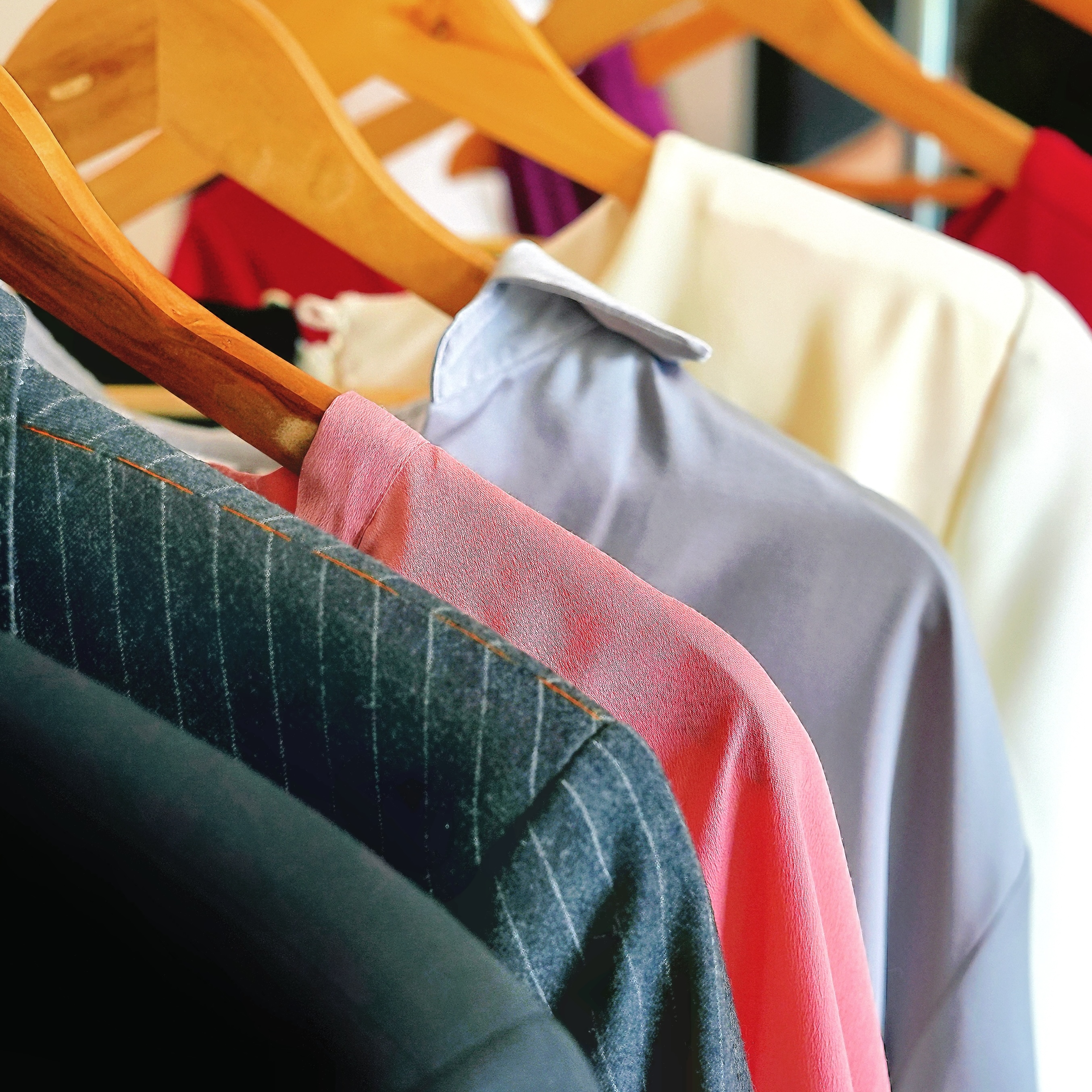 Various outfits on a clothing rail ready to be reviewed